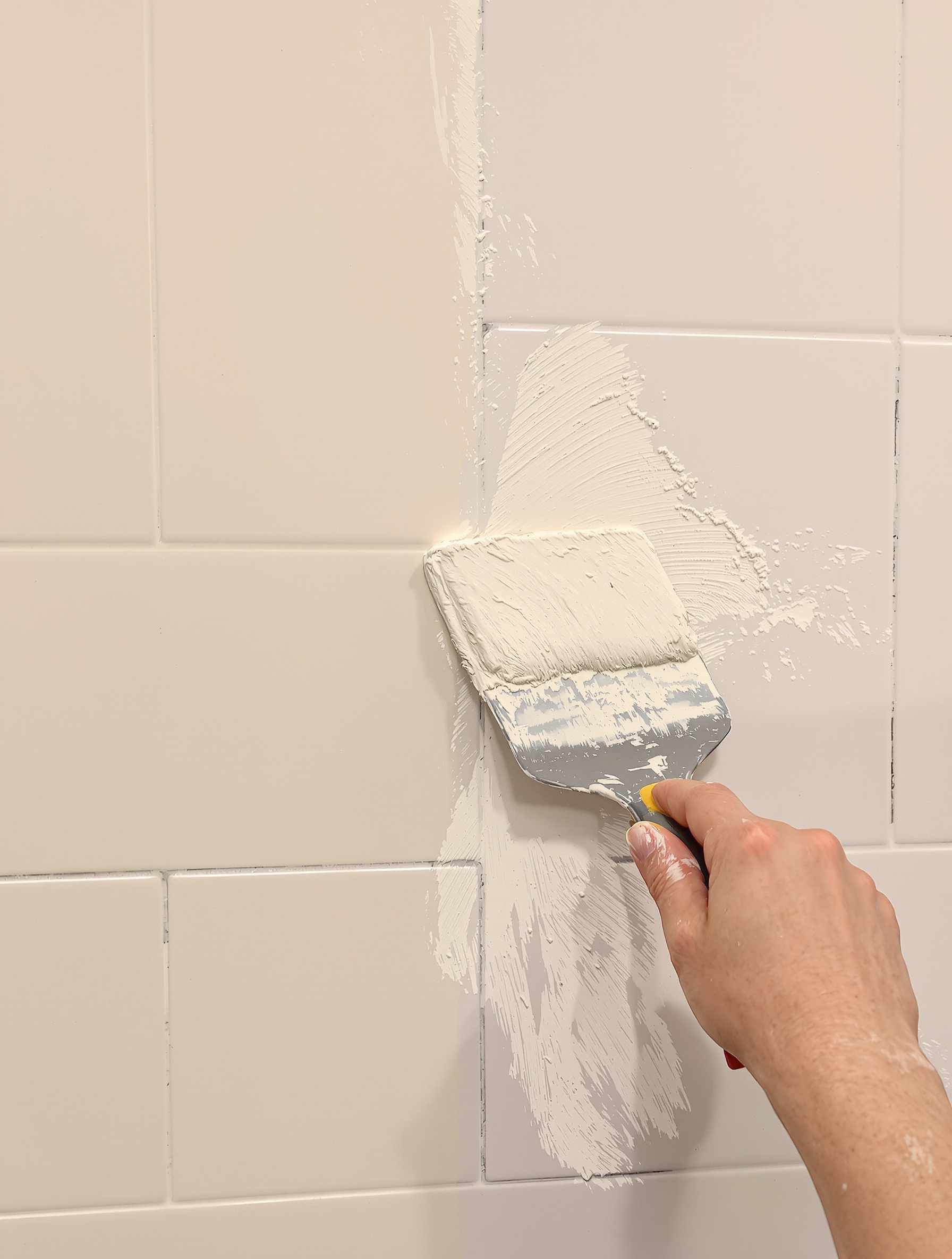 Application d'enduit sur carrelage mural préparation avant papier peint salle de bain